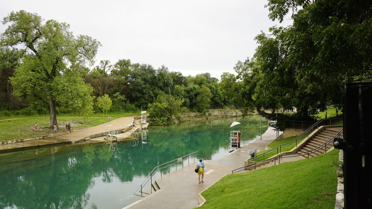 View of the tranquil Barton Springs in Texas with green trees and clear water