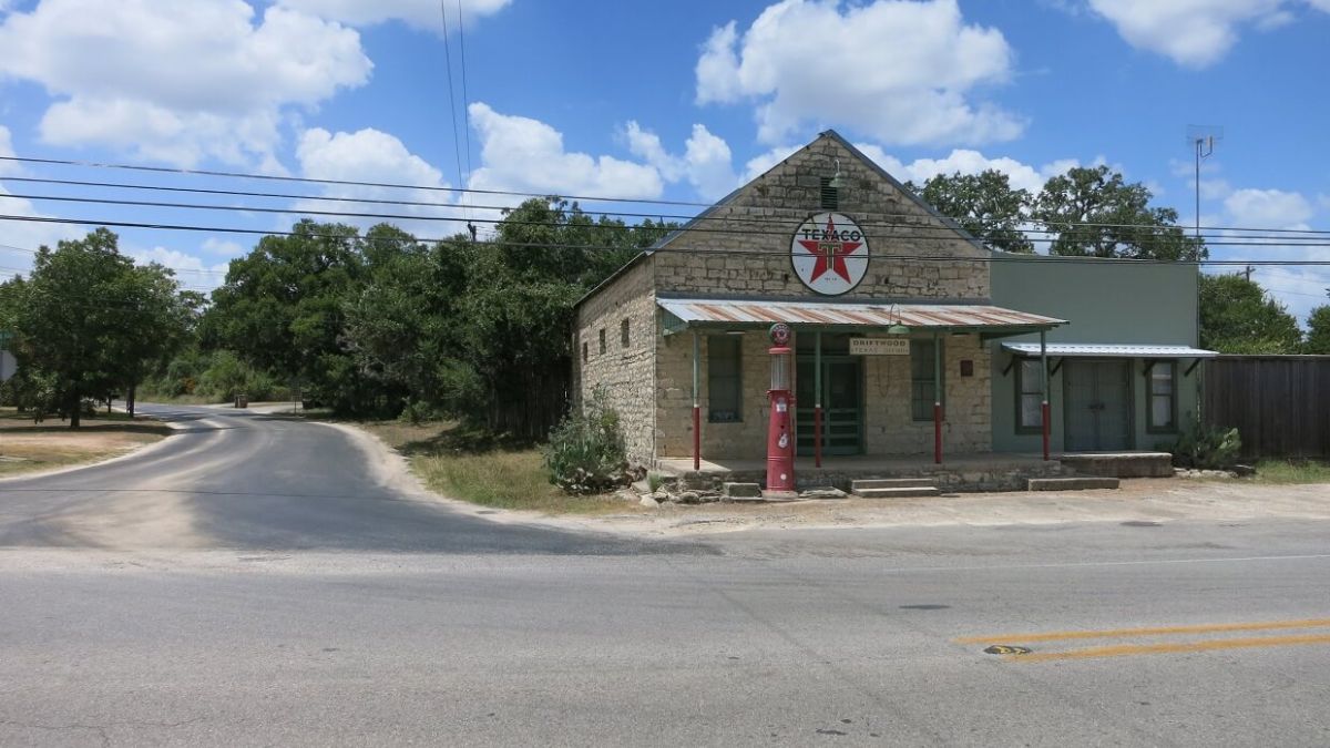 A small store featuring a prominent cross on its front facade.