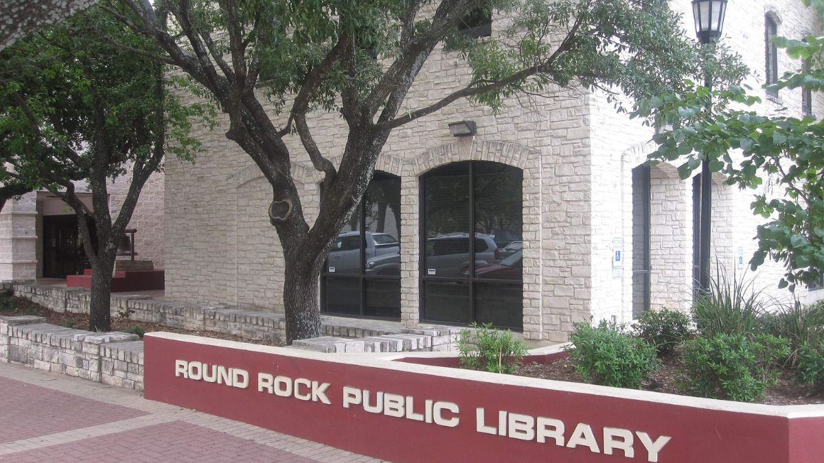 Round Rock Public Library exterior, featuring modern architecture and landscaped grounds, inviting visitors to explore.