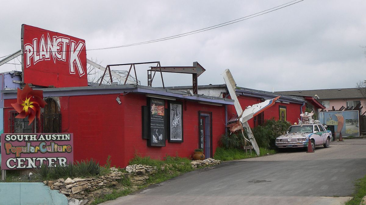 A red building featuring a prominent sign on its facade.